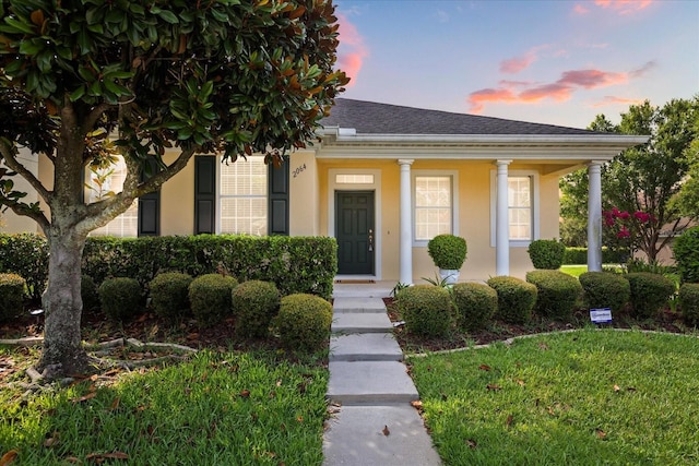 2064 Rafton Rd, Apopka, FL 32703 - view of front of house featuring roof with shingles, a porch, and stucco siding