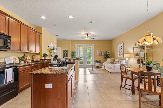 2064 Rafton Rd, Apopka, FL 32703 - kitchen featuring black appliances, dark stone counters, light tile patterned flooring, a peninsula, and open floor plan