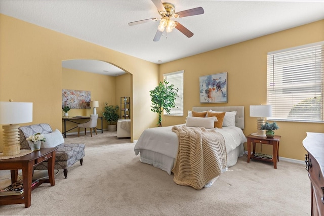 2064 Rafton Rd, Apopka, FL 32703 - carpeted bedroom featuring multiple windows, arched walkways, a desk, and ceiling fan
