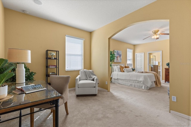 2064 Rafton Rd, Apopka, FL 32703 - bedroom featuring carpet floors, arched walkways, ceiling fan, and ensuite bath