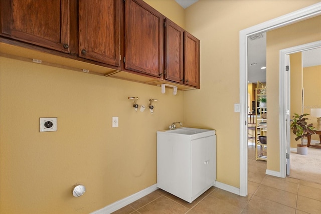 2064 Rafton Rd, Apopka, FL 32703 - washroom featuring hookup for an electric dryer, light tile patterned floors, cabinet space, and washer hookup