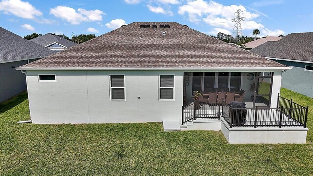 1627 Mclucas Ln, The Villages, FL 34762 - back of house featuring roof with shingles, a lawn, and a sunroom