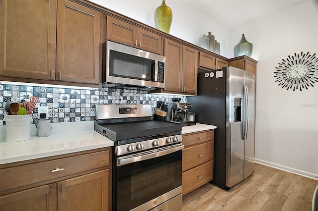 1627 Mclucas Ln, The Villages, FL 34762 - kitchen with appliances with stainless steel finishes, light wood finished floors, tasteful backsplash, light countertops, and baseboards