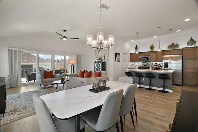 1627 Mclucas Ln, The Villages, FL 34762 - dining space featuring ceiling fan, a chandelier, light wood-type flooring, recessed lighting, and vaulted ceiling