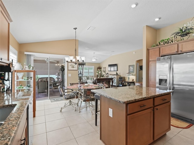 2998 Kramer Ct, The Villages, FL 32163 - kitchen featuring stainless steel refrigerator with ice dispenser, light tile patterned floors, plenty of natural light, lofted ceiling, and pendant lighting