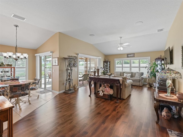 2998 Kramer Ct, The Villages, FL 32163 - living area featuring lofted ceiling, wood finished floors, ceiling fan, a chandelier, and a textured ceiling