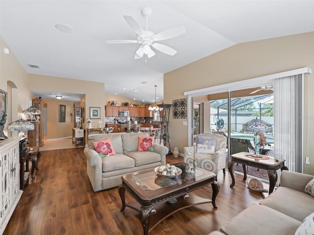 2998 Kramer Ct, The Villages, FL 32163 - living area with vaulted ceiling, a ceiling fan, and wood finished floors