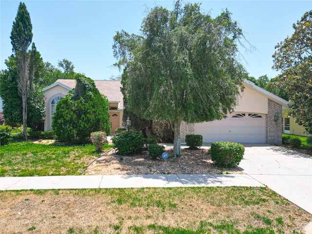 6147 N Whispering Oak Loop, Beverly Hills, FL 34465 - obstructed view of property with concrete driveway, a garage, and brick siding