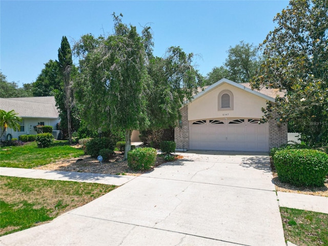 6147 N Whispering Oak Loop, Beverly Hills, FL 34465 - view of property hidden behind natural elements with a garage, driveway, stucco siding, a front lawn, and brick siding
