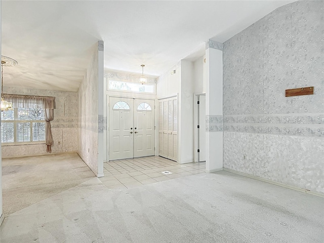 6147 N Whispering Oak Loop, Beverly Hills, FL 34465 - carpeted entryway with tile patterned floors and a chandelier