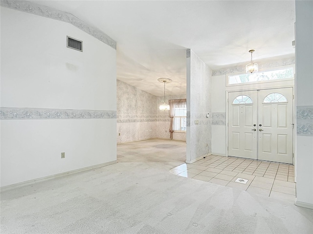6147 N Whispering Oak Loop, Beverly Hills, FL 34465 - carpeted foyer with a chandelier and tile patterned flooring