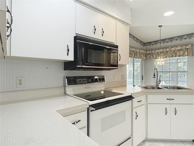 6147 N Whispering Oak Loop, Beverly Hills, FL 34465 - kitchen with white electric range oven, black microwave, a sink, light countertops, and white cabinets