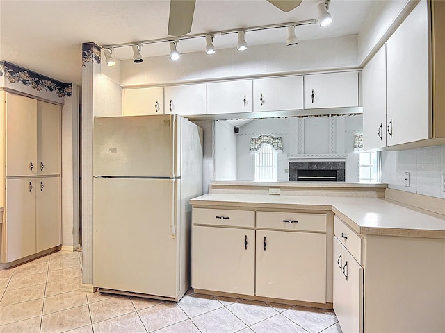 6147 N Whispering Oak Loop, Beverly Hills, FL 34465 - kitchen with freestanding refrigerator, light countertops, rail lighting, and light tile patterned floors