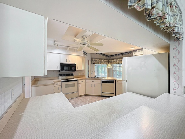 6147 N Whispering Oak Loop, Beverly Hills, FL 34465 - kitchen with white appliances, a sink, a ceiling fan, light tile patterned floors, and white cabinetry