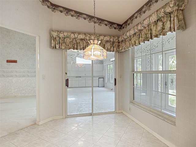 6147 N Whispering Oak Loop, Beverly Hills, FL 34465 - unfurnished dining area featuring a chandelier, tile patterned floors, baseboards, and wallpapered walls