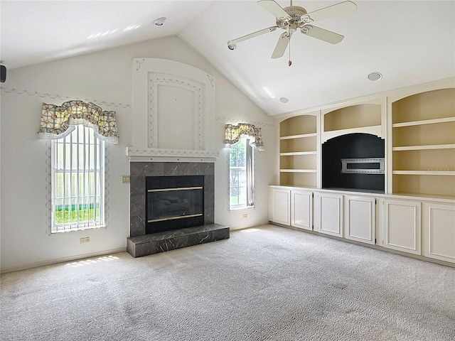 6147 N Whispering Oak Loop, Beverly Hills, FL 34465 - unfurnished living room featuring a premium fireplace, carpet flooring, lofted ceiling, ceiling fan, and baseboards