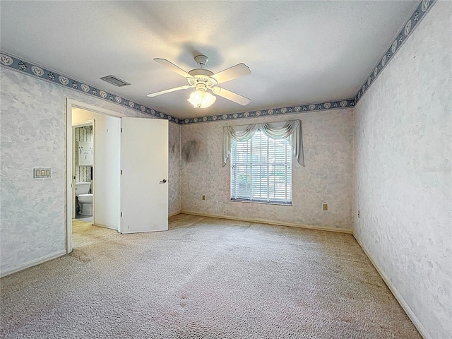 6147 N Whispering Oak Loop, Beverly Hills, FL 34465 - unfurnished bedroom featuring light colored carpet, a textured wall, a textured ceiling, a ceiling fan, and baseboards
