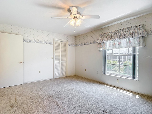 6147 N Whispering Oak Loop, Beverly Hills, FL 34465 - unfurnished bedroom featuring wallpapered walls, carpet floors, a closet, and ceiling fan