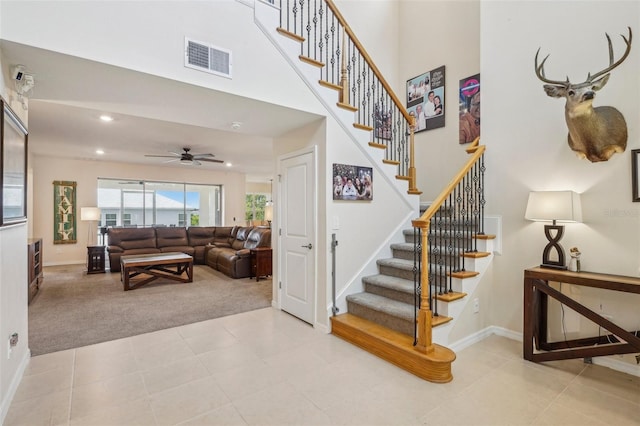 stairway with carpet flooring, baseboards, ceiling fan, a high ceiling, and recessed lighting