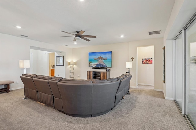 living area featuring light carpet, a ceiling fan, recessed lighting, and baseboards