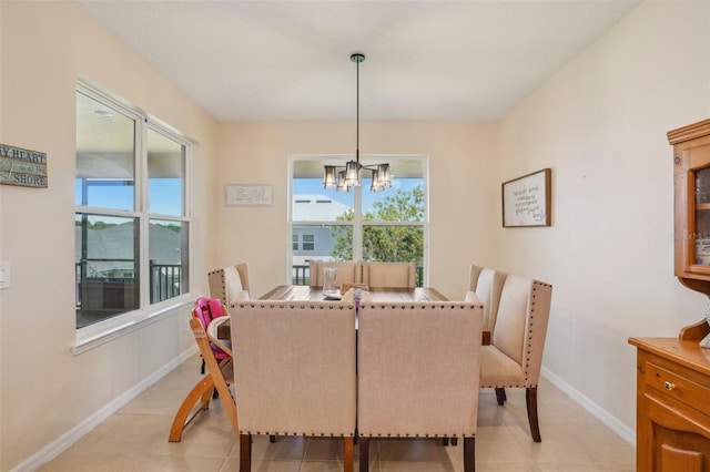 dining area featuring a chandelier, baseboards, and light tile patterned floors