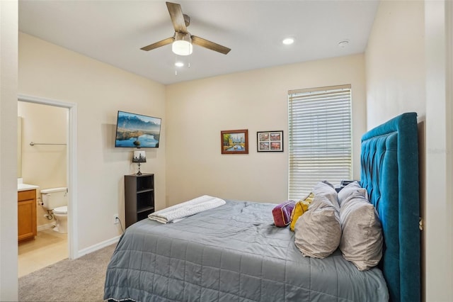 bedroom with light carpet, recessed lighting, ceiling fan, ensuite bathroom, and baseboards