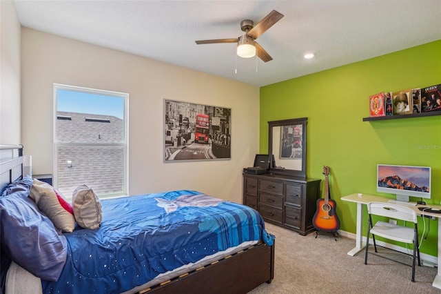 carpeted bedroom featuring baseboards and ceiling fan