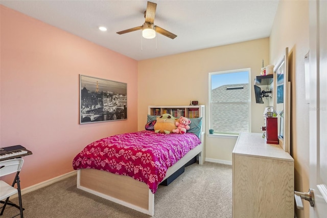 carpeted bedroom featuring baseboards and ceiling fan