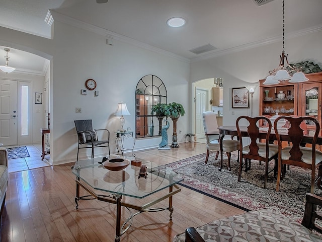 3112 Burbank Ln, The Villages, FL 32162 - living room with arched walkways, crown molding, wood finished floors, and baseboards
