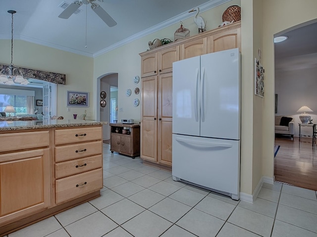3112 Burbank Ln, The Villages, FL 32162 - kitchen featuring freestanding refrigerator, light brown cabinets, arched walkways, light tile patterned flooring, and ceiling fan