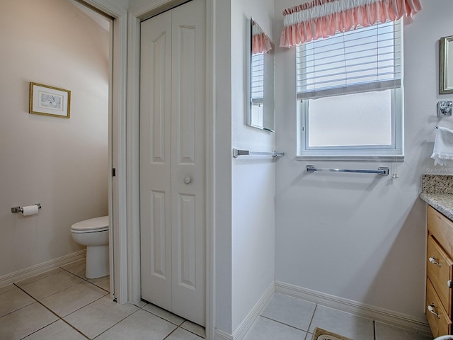 3112 Burbank Ln, The Villages, FL 32162 - bathroom with vanity, a closet, tile patterned flooring, toilet, and plenty of natural light