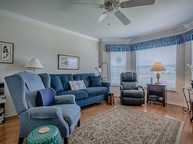 3112 Burbank Ln, The Villages, FL 32162 - living area with ornamental molding, healthy amount of natural light, a ceiling fan, wood finished floors, and baseboards