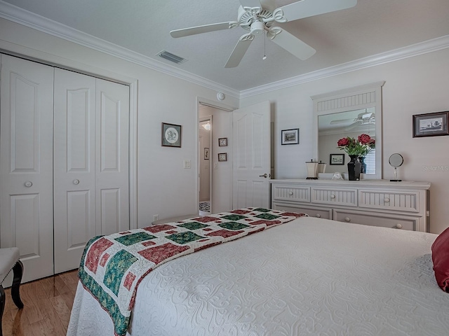 3112 Burbank Ln, The Villages, FL 32162 - bedroom with ornamental molding, wood finished floors, a ceiling fan, and a closet