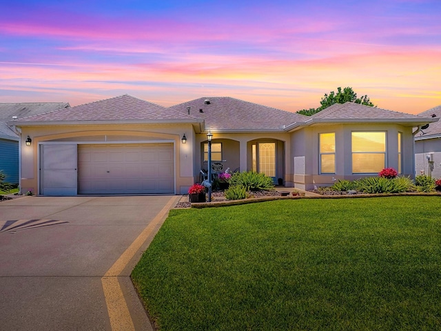 3112 Burbank Ln, The Villages, FL 32162 - ranch-style house featuring concrete driveway, a yard, an attached garage, and stucco siding