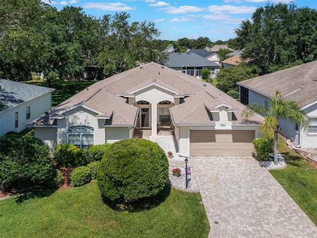 25243 River Crest Dr, Leesburg, FL 34748 - single story home with a garage, decorative driveway, and a front lawn