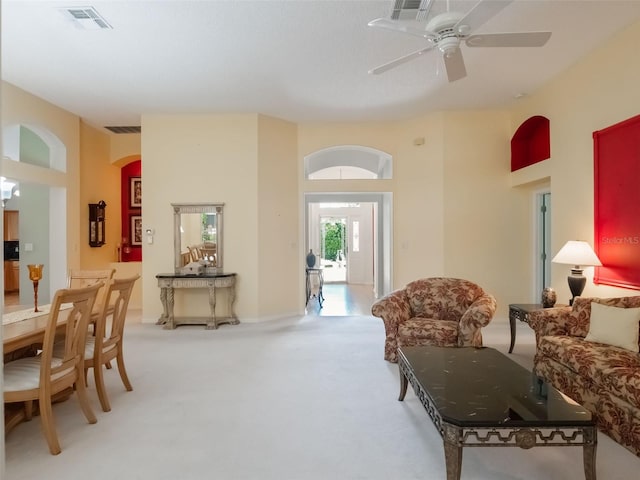 25243 River Crest Dr, Leesburg, FL 34748 - living room featuring carpet, a ceiling fan, and arched walkways