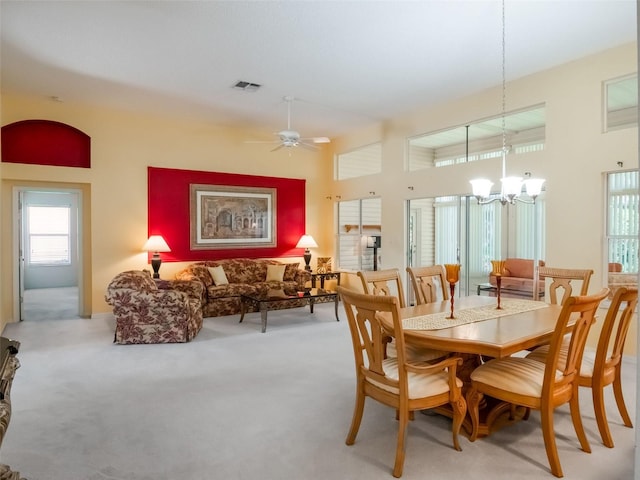 25243 River Crest Dr, Leesburg, FL 34748 - dining room with a chandelier, light carpet, and a ceiling fan