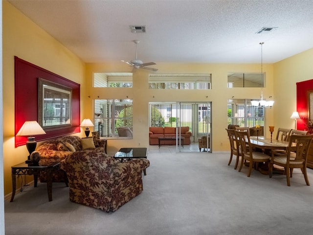 25243 River Crest Dr, Leesburg, FL 34748 - carpeted living room with a chandelier, ceiling fan, baseboards, and a high ceiling