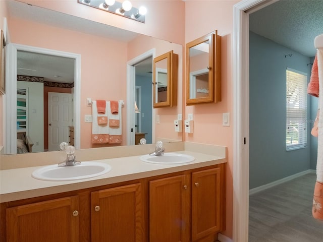 25243 River Crest Dr, Leesburg, FL 34748 - full bath featuring double vanity, wood finished floors, and baseboards