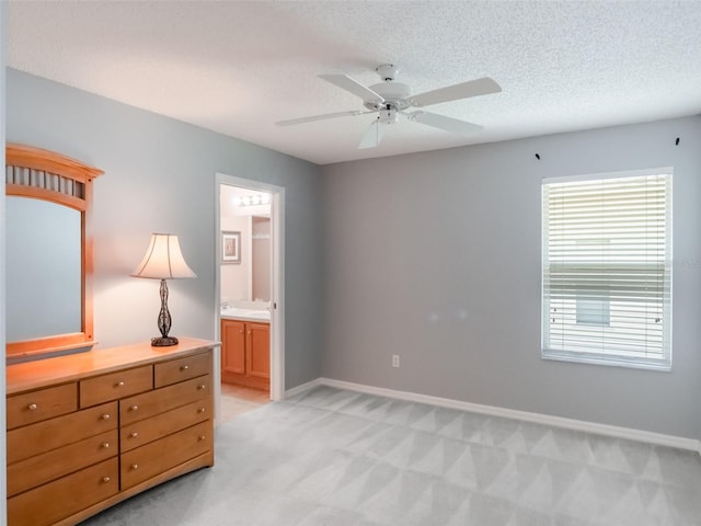 25243 River Crest Dr, Leesburg, FL 34748 - bedroom with light colored carpet, baseboards, ensuite bath, ceiling fan, and a textured ceiling