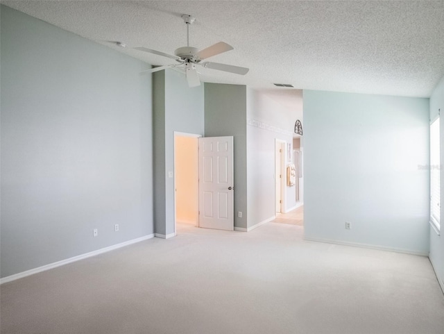 25243 River Crest Dr, Leesburg, FL 34748 - unfurnished bedroom with carpet flooring, baseboards, lofted ceiling, a textured ceiling, and a ceiling fan