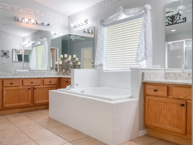 25243 River Crest Dr, Leesburg, FL 34748 - full bathroom featuring a ceiling fan, tile patterned floors, vaulted ceiling, vanity, and a bath