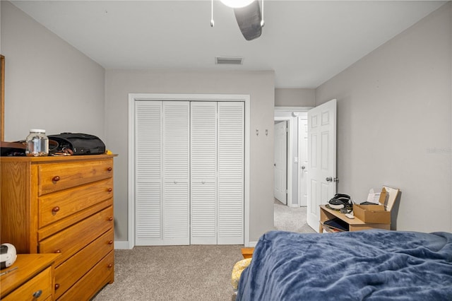 8180 N Duval Dr, Citrus Springs, FL 34434 - bedroom featuring light colored carpet, a closet, and a ceiling fan