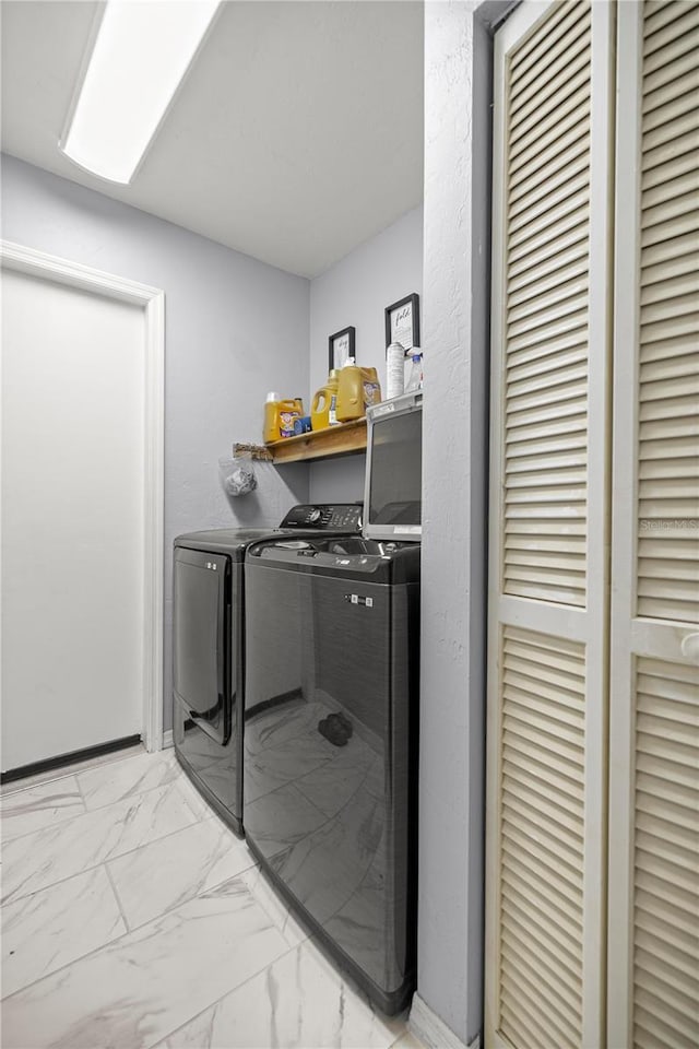 8180 N Duval Dr, Citrus Springs, FL 34434 - laundry area featuring washing machine and clothes dryer and light marble finish floors
