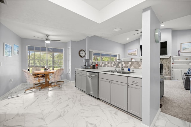 8180 N Duval Dr, Citrus Springs, FL 34434 - kitchen with stainless steel dishwasher, a sink, gray cabinets, a ceiling fan, and light marble finish floors
