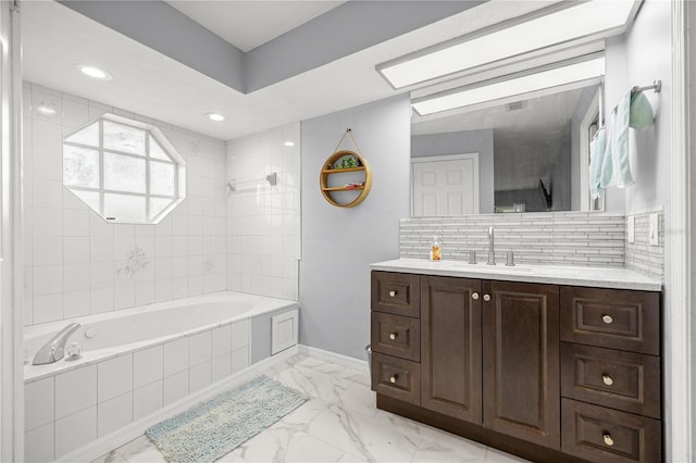 8180 N Duval Dr, Citrus Springs, FL 34434 - bathroom featuring marble look tiles, vanity, baseboards, backsplash, and tiled shower / bath combo
