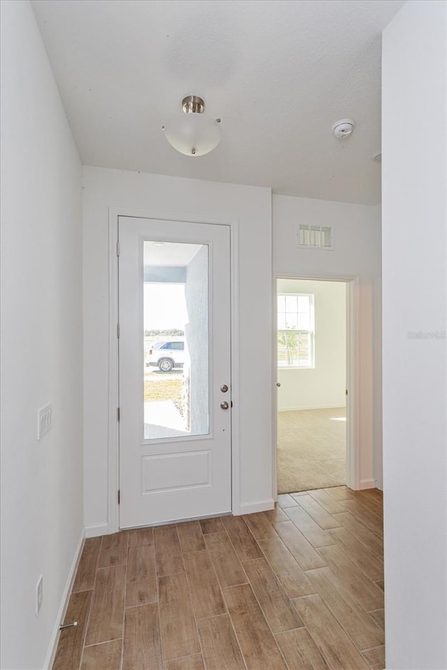 5017 Balsam Falls Rd, Deland, FL 32724 - doorway to outside featuring light wood-style flooring and baseboards