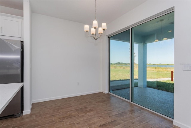 5017 Balsam Falls Rd, Deland, FL 32724 - unfurnished dining area with wood finished floors, a chandelier, and baseboards