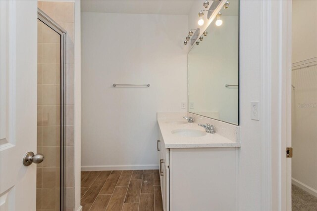 5017 Balsam Falls Rd, Deland, FL 32724 - full bath featuring tiled shower, double vanity, baseboards, and wood finished floors