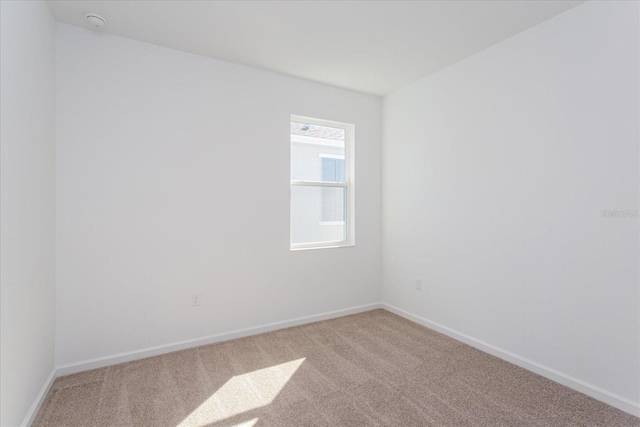 5017 Balsam Falls Rd, Deland, FL 32724 - spare room featuring light colored carpet, baseboards, and a smoke detector